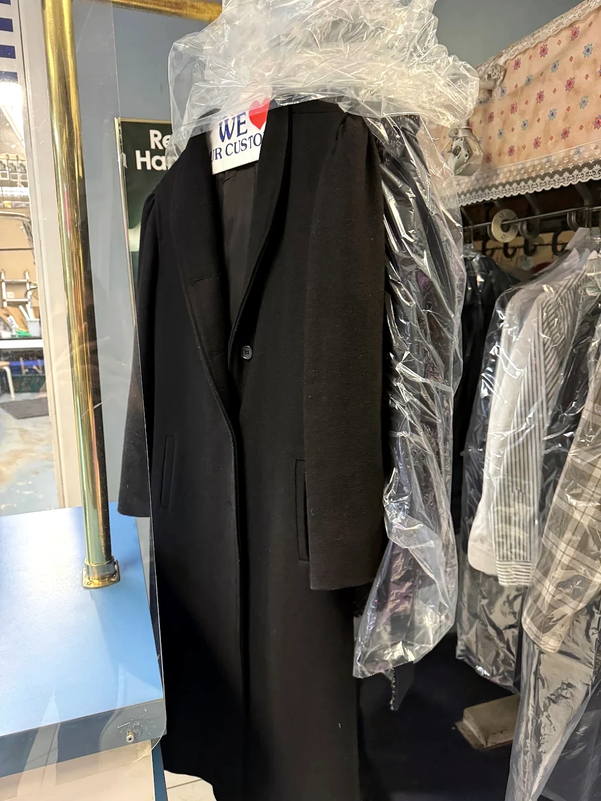 Long black coat professionally cleaned at Royal Oak Drycleaners