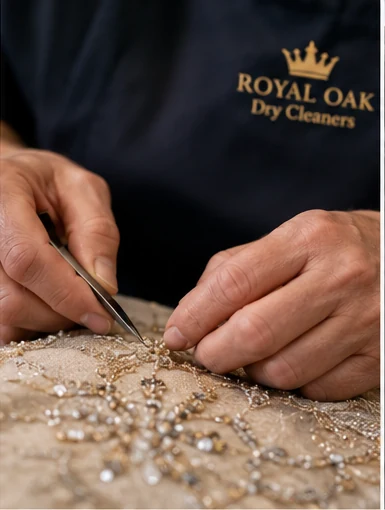 Detailed hand inspection of an embellished luxury garment