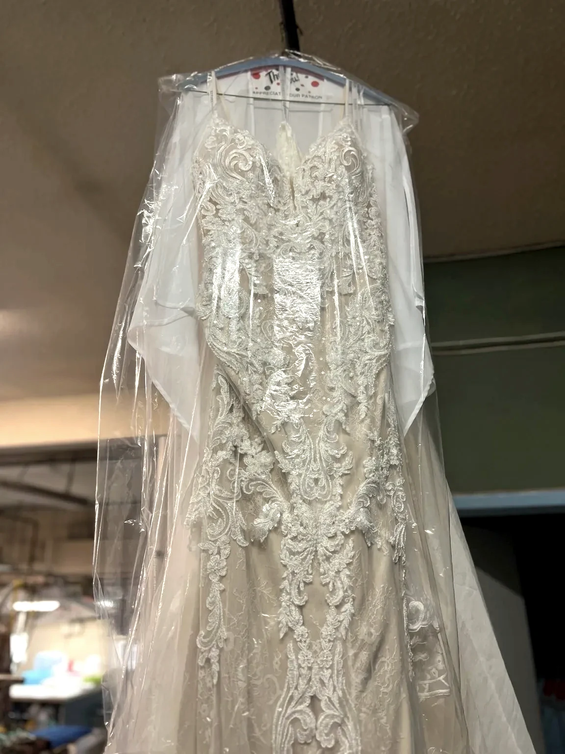 Detailed lace wedding gown after cleaning at Royal Oak Drycleaners